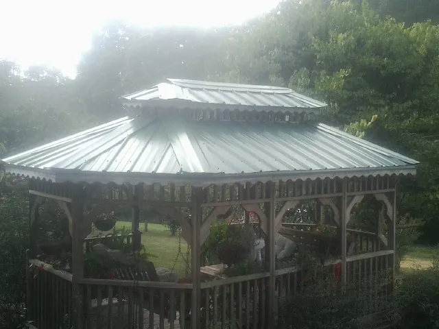 Two tier green metal roof on a garden gazebo in Kamas
